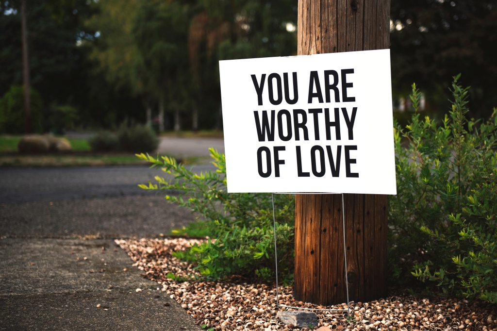This image has an empty alt attribute; its file name is canva-you-are-worthy-of-love-signage-on-brown-wooden-post-taken.jpg